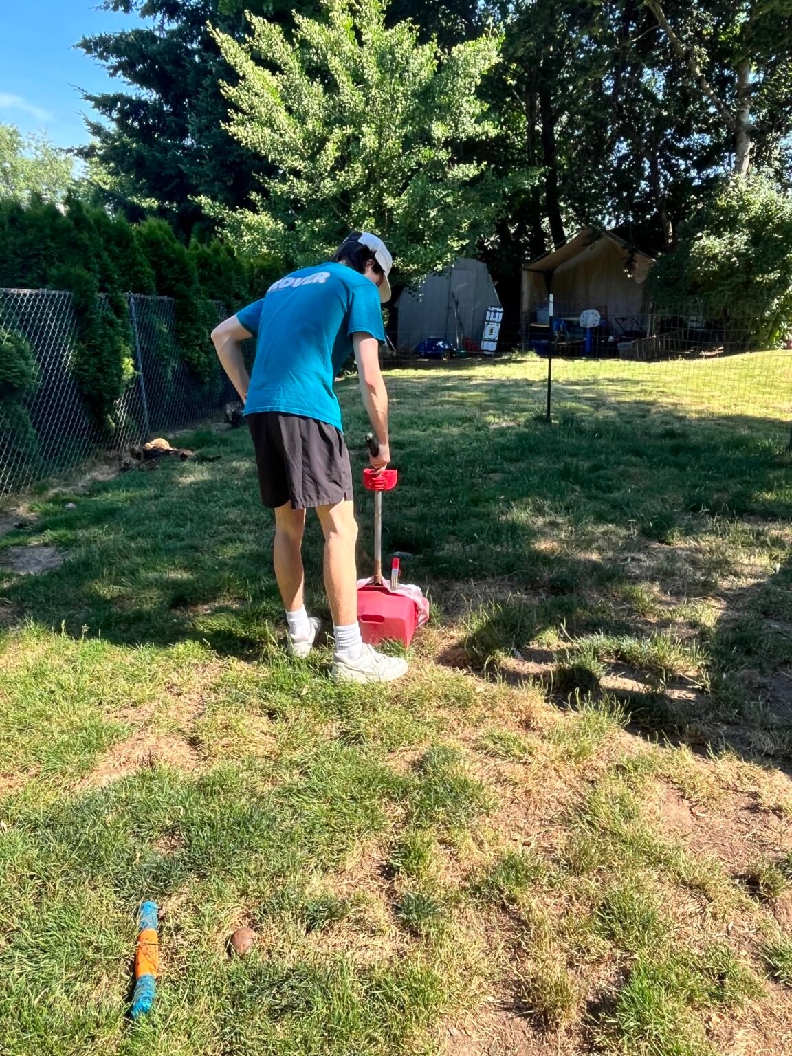 Rover Scoopers technician removing dog waste from a Portland-area yard